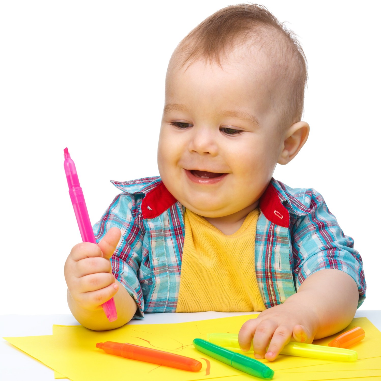 Young boy colouring with crayons